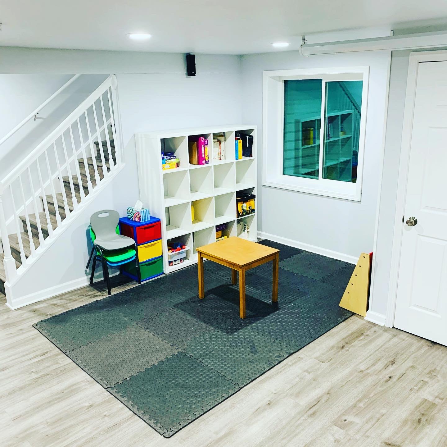 Indoor play area with stairs and storage cubbies